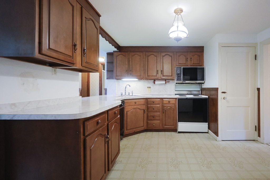 17 Sagamore Road Belmont, MA 02478 - Photo 5 of 35 a kitchen with stainless steel appliances granite countertop a sink a stove a refrigerator and cabinets