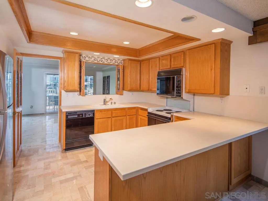 51 Green Turtle Road Coronado, CA 92118 - Photo 19 of 46 a kitchen with a sink a stove and chairs