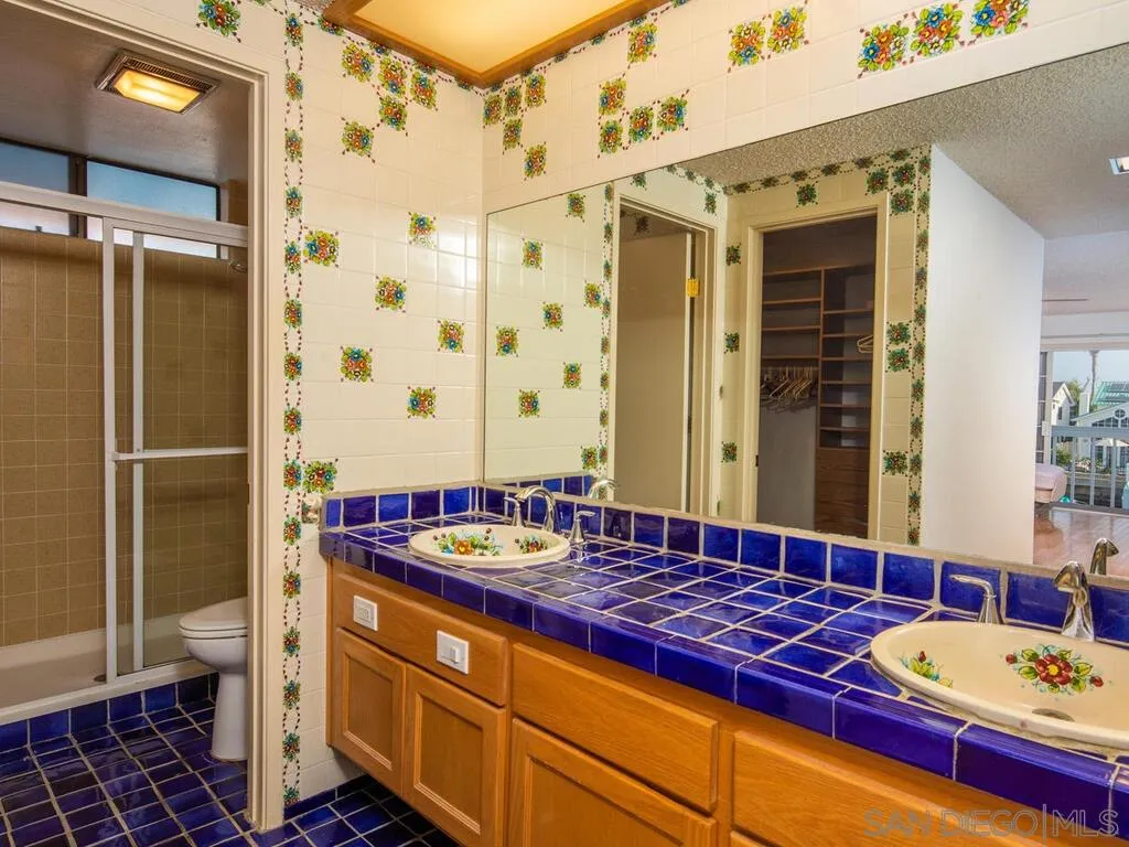 51 Green Turtle Road Coronado, CA 92118 - Photo 30 of 46 a bathroom with a double vanity sink and a mirror