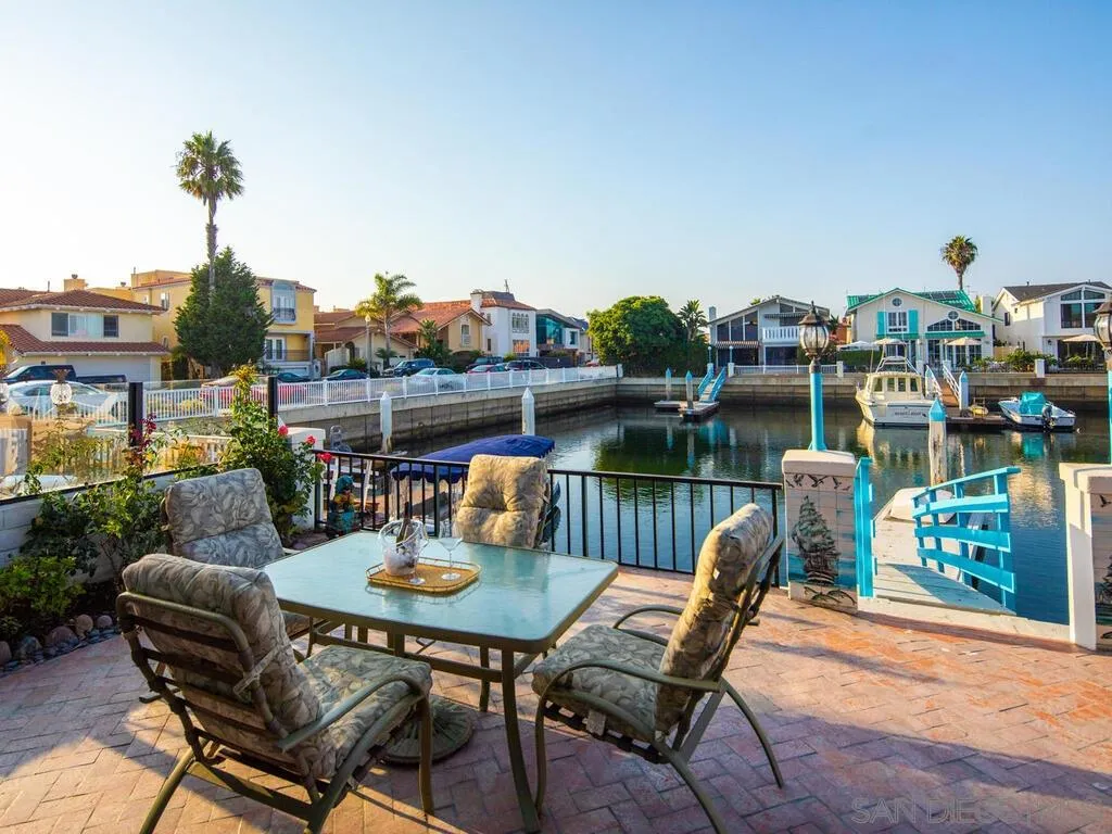 51 Green Turtle Road Coronado, CA 92118 - Photo 40 of 46 a table and chairs sitting in front of a lake