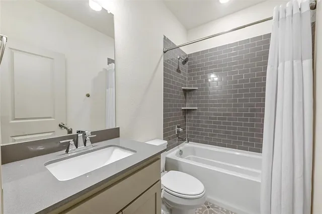 a bathroom with a sink toilet tub and shower
