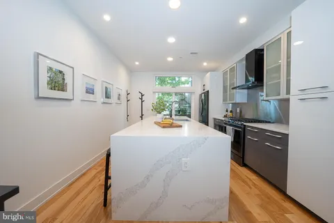 a kitchen with stainless steel appliances a refrigerator and a stove top oven