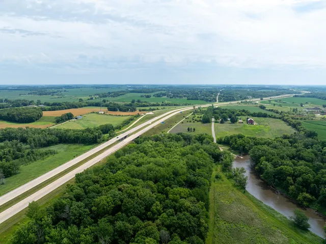 an aerial view of huge green field with lots of green space