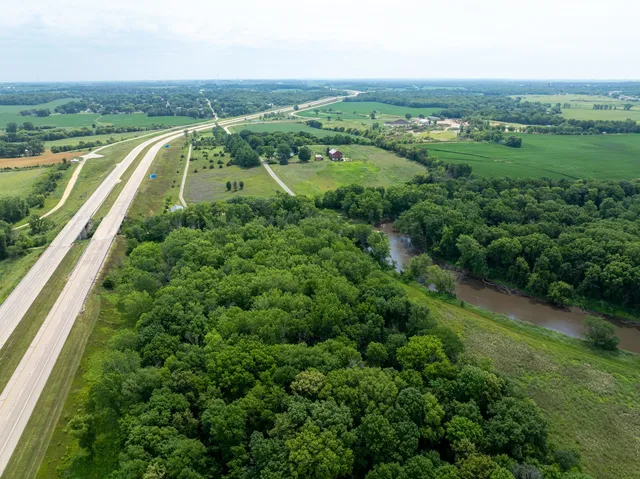 an aerial view of a houses with outdoor space and trees