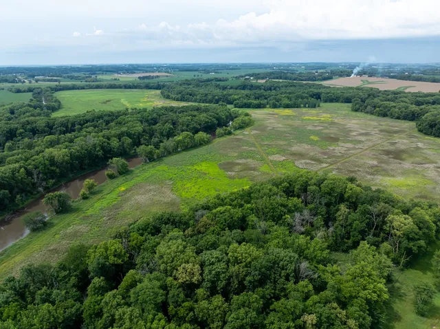 an aerial view of residential houses with outdoor space and trees