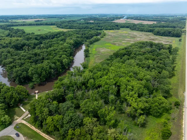 a view of a green field with a view of a city