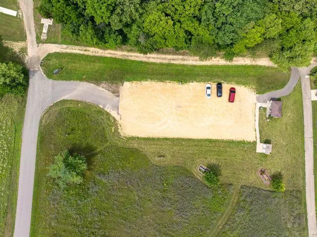 an aerial view of a residential houses with outdoor space and street view