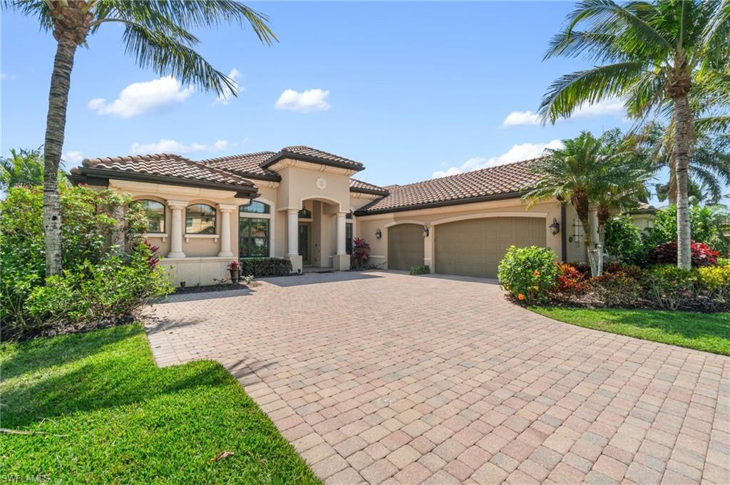 Mediterranean / spanish-style house featuring an attached garage, decorative driveway, stucco siding, and a tiled roof