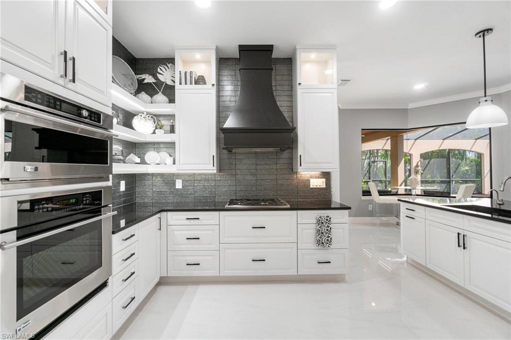 3440 Runaway Lane Naples, FL 34114 - Photo 11 of 42 Kitchen with custom range hood, appliances with stainless steel finishes, open shelves, backsplash, and white cabinets