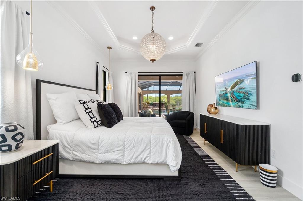 3440 Runaway Lane Naples, FL 34114 - Photo 15 of 42 Bedroom featuring access to outside, crown molding, a raised ceiling, and recessed lighting