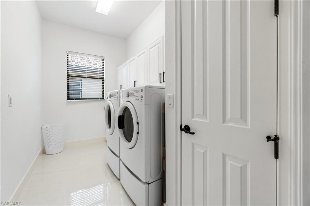 3440 Runaway Lane Naples, FL 34114 - Photo 20 of 42 Washroom featuring separate washer and dryer and cabinet space