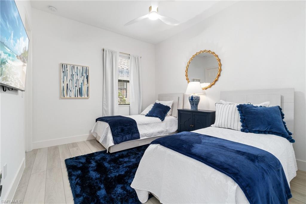 3440 Runaway Lane Naples, FL 34114 - Photo 21 of 42 Bedroom with wood finished floors and a ceiling fan