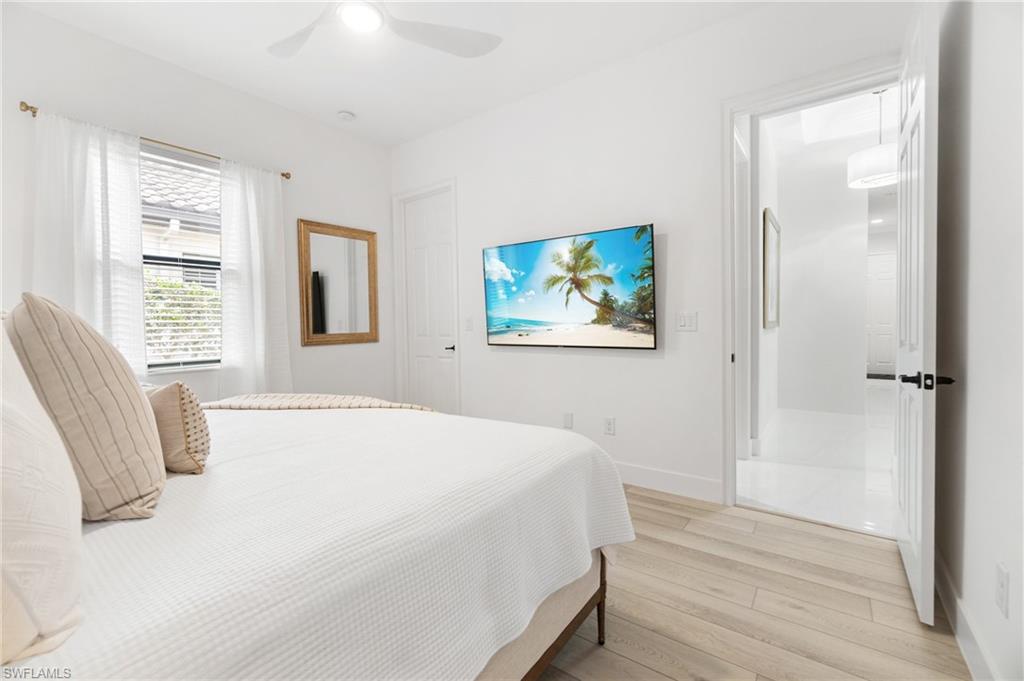 3440 Runaway Lane Naples, FL 34114 - Photo 24 of 42 Bedroom with light wood-style flooring and a ceiling fan