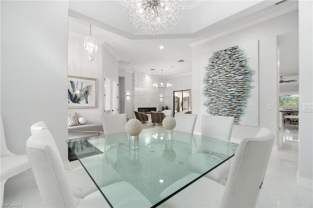 3440 Runaway Lane Naples, FL 34114 - Photo 3 of 42 Dining area featuring a chandelier, crown molding, marble tiled flooring, and recessed lighting