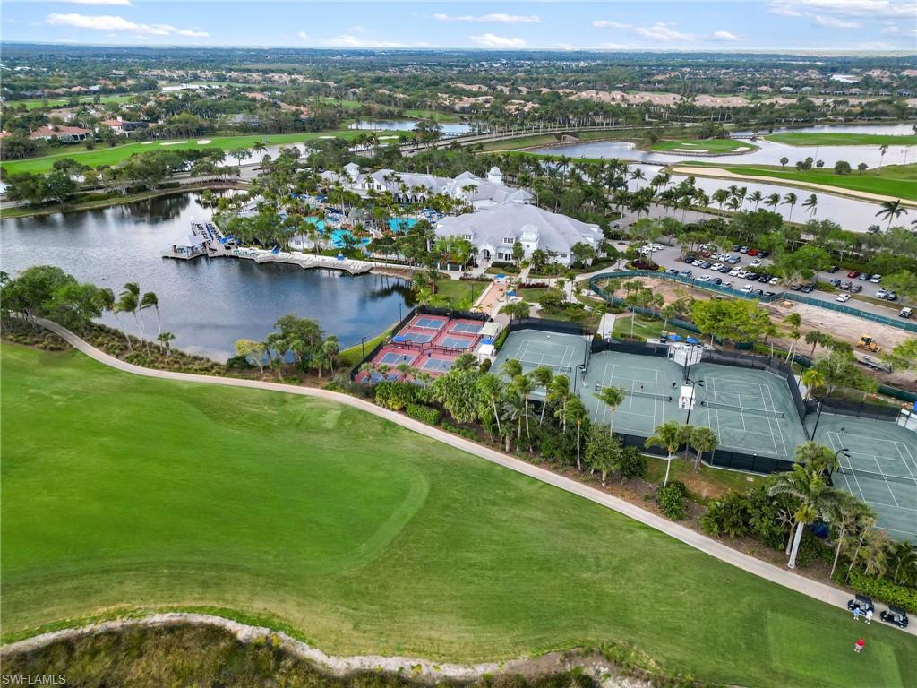 3440 Runaway Lane Naples, FL 34114 - Photo 42 of 42 Aerial view of property and surrounding area featuring a large body of water, a golf course, and nearby suburban area