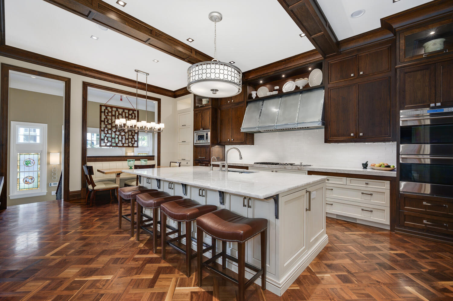 4136 North Greenview Avenue Chicago, IL 60613 - Photo 13 of 56 a kitchen with stainless steel appliances granite countertop a stove a sink dishwasher and a dining table with wooden floor