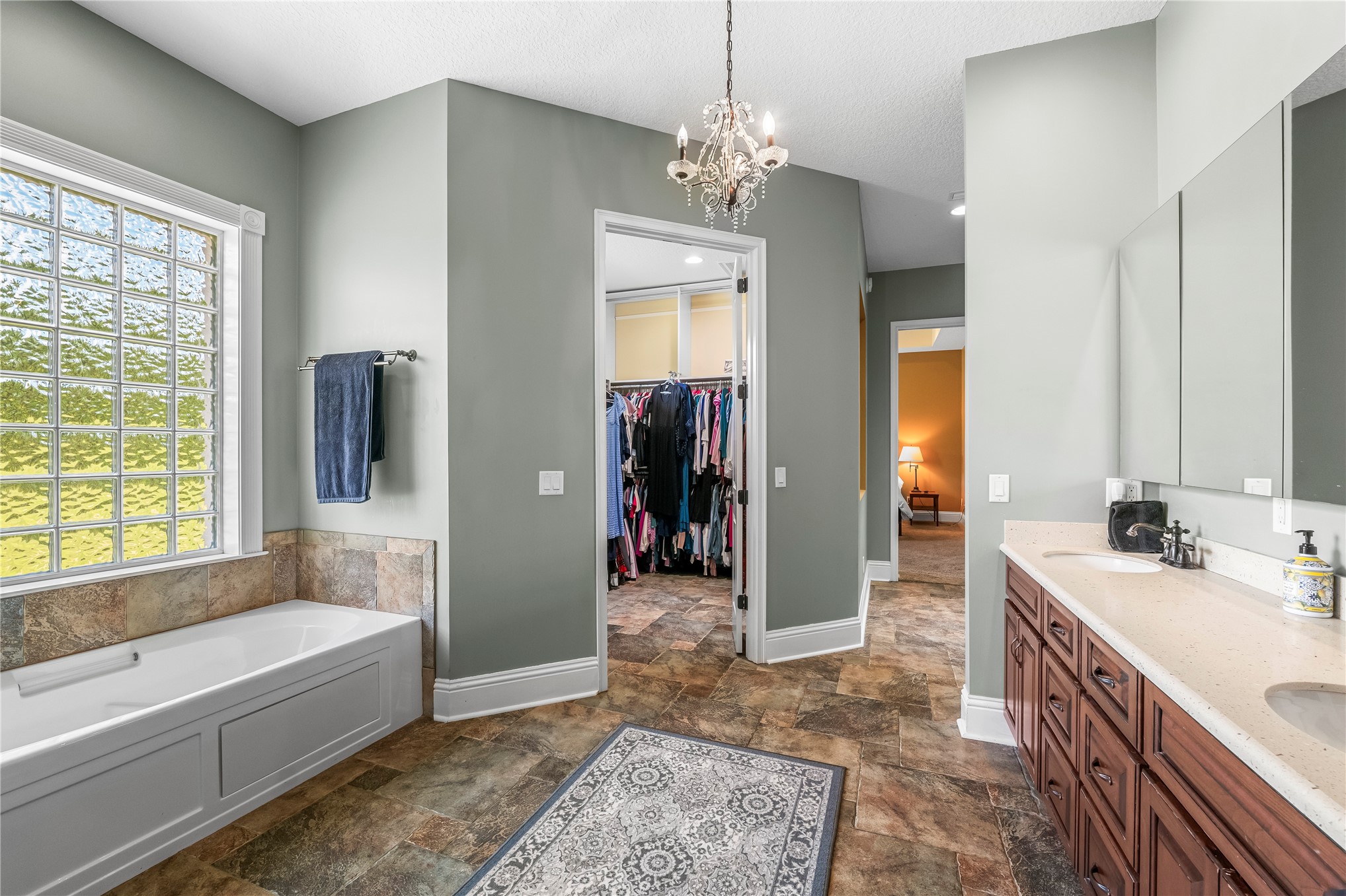 27247 Hallman Road Hilliard, FL 32046 - Photo 32 of 59 a spacious bathroom with a tub sink and a mirror