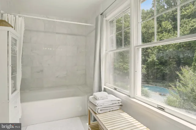 a bathroom with a bathtub and a shower