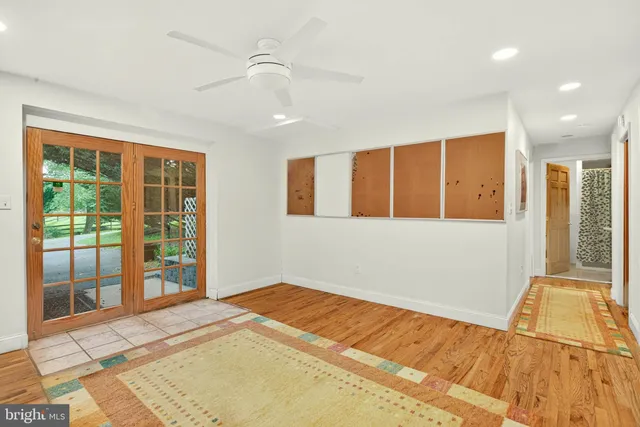 a room with a table chairs and a refrigerator