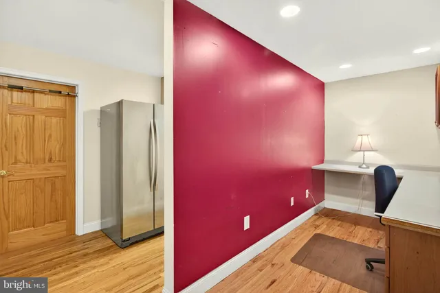 a kitchen with a sink a refrigerator and cabinets