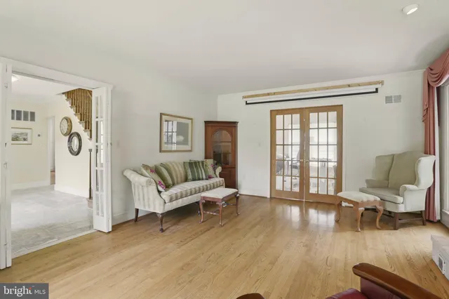 a living room with furniture window and wooden floor