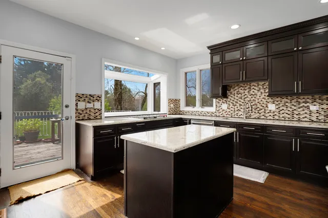 a kitchen with a refrigerator and a sink