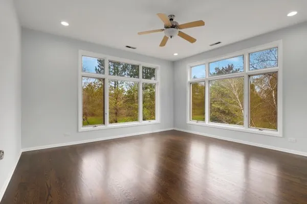 a view of empty room with wooden floor