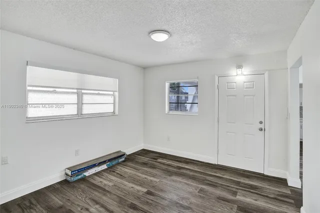 a view of a room with wooden floor and window