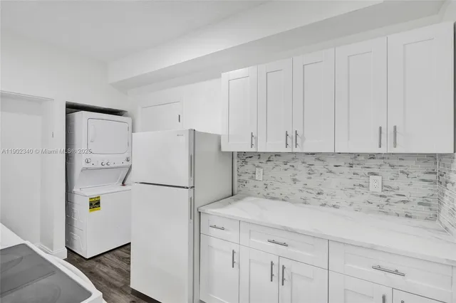 a white refrigerator freezer sitting in a kitchen