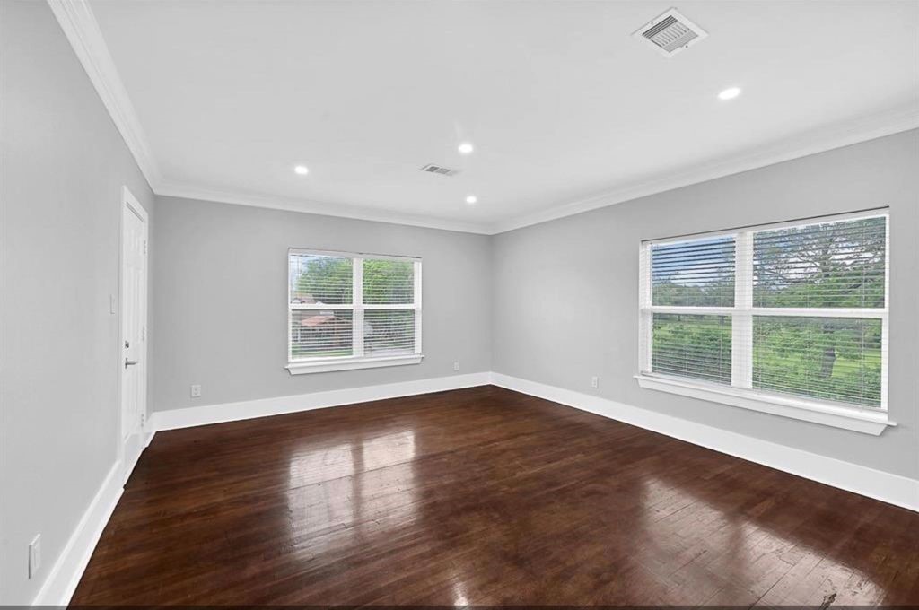12430 Pecan Court Houston, TX 77013 - Photo 7 of 10 a view of an empty room with wooden floor and a window