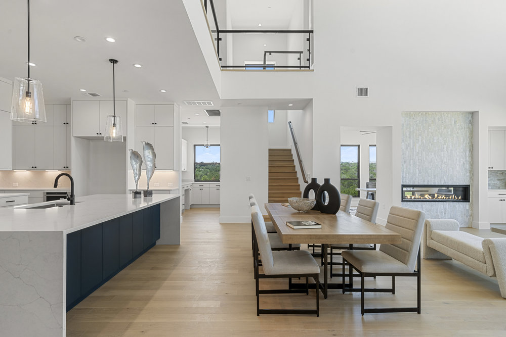 6101 Adhara Pass Austin, TX 78730 - Photo 16 of 40 a view of a dining room and livingroom with furniture wooden floor a rug a painting and a chandelier