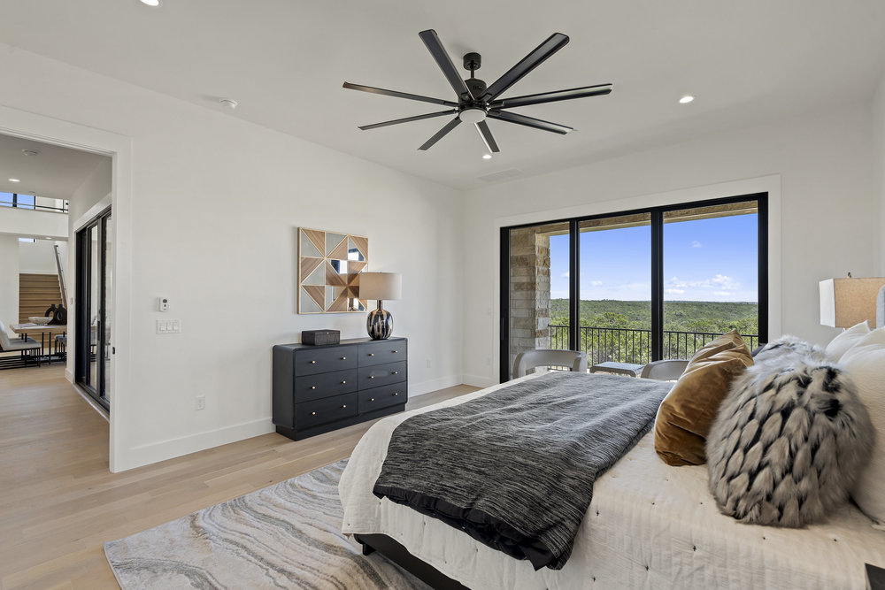 6101 Adhara Pass Austin, TX 78730 - Photo 21 of 40 a bedroom with a large bed and a large window