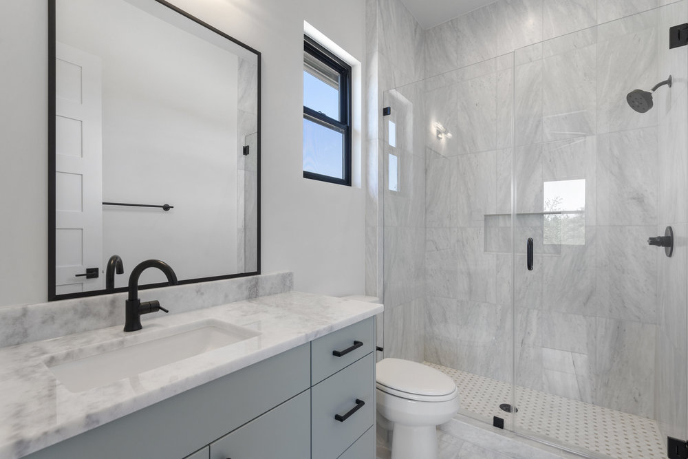 6101 Adhara Pass Austin, TX 78730 - Photo 29 of 40 a bathroom with a sink a toilet and a mirror