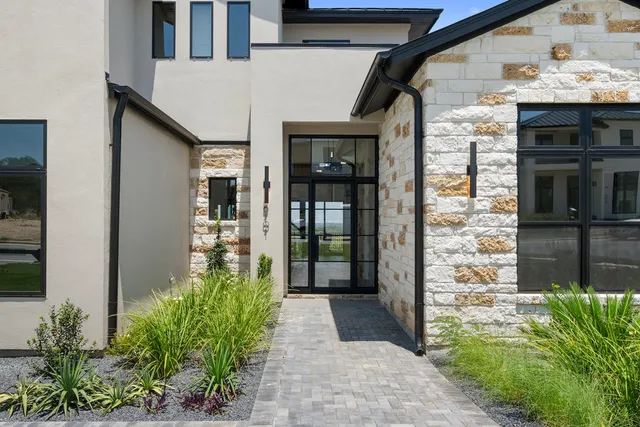 a hallway with potted plants in front of door