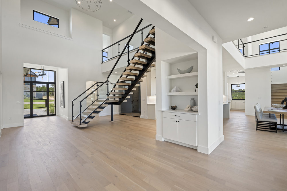 6101 Adhara Pass Austin, TX 78730 - Photo 5 of 40 a view of empty room with wooden floor and stairs
