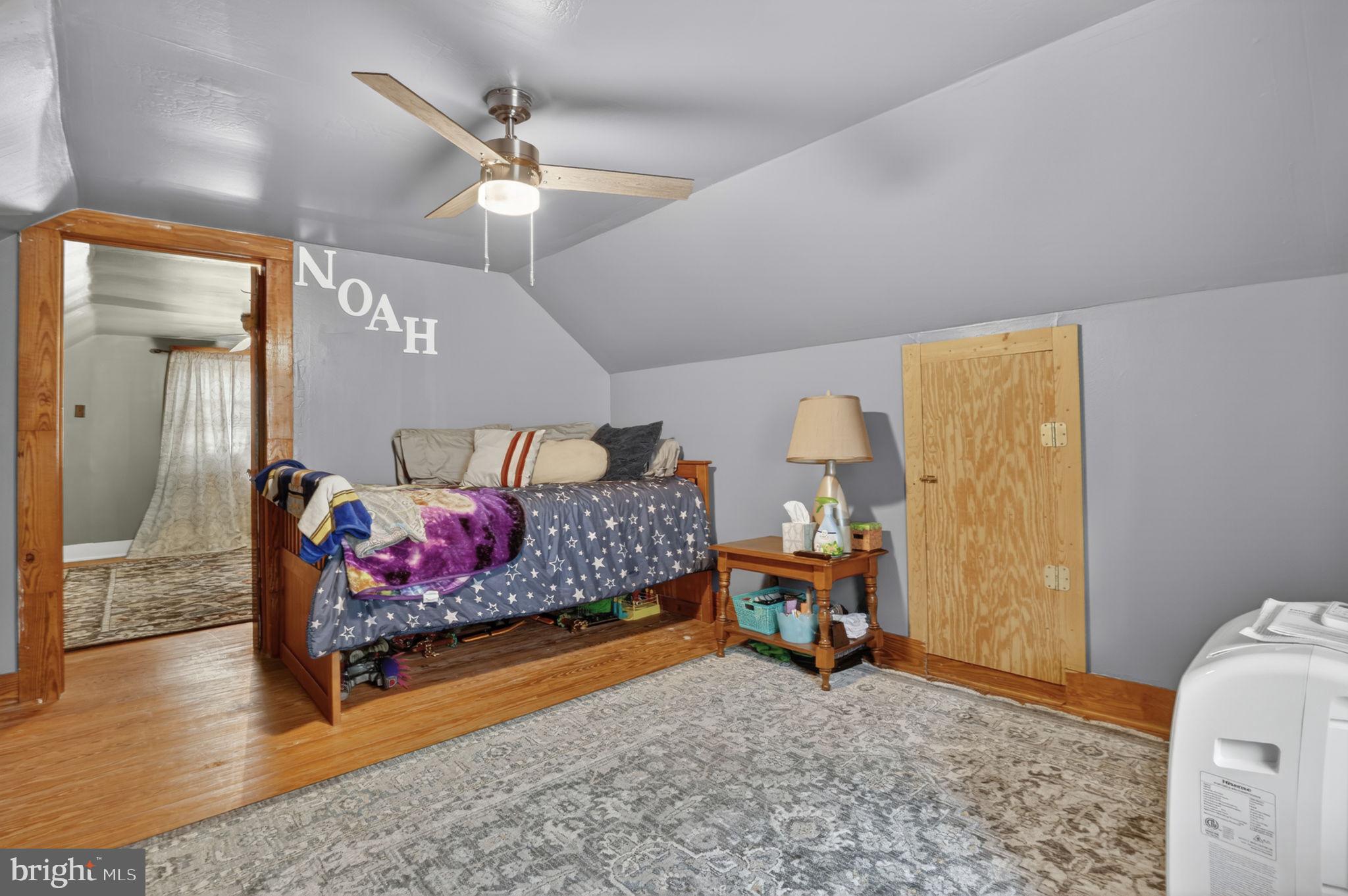 7278 Fleming Road New Church, VA 23415 - Photo 23 of 44 a bedroom with a bed and wooden floor