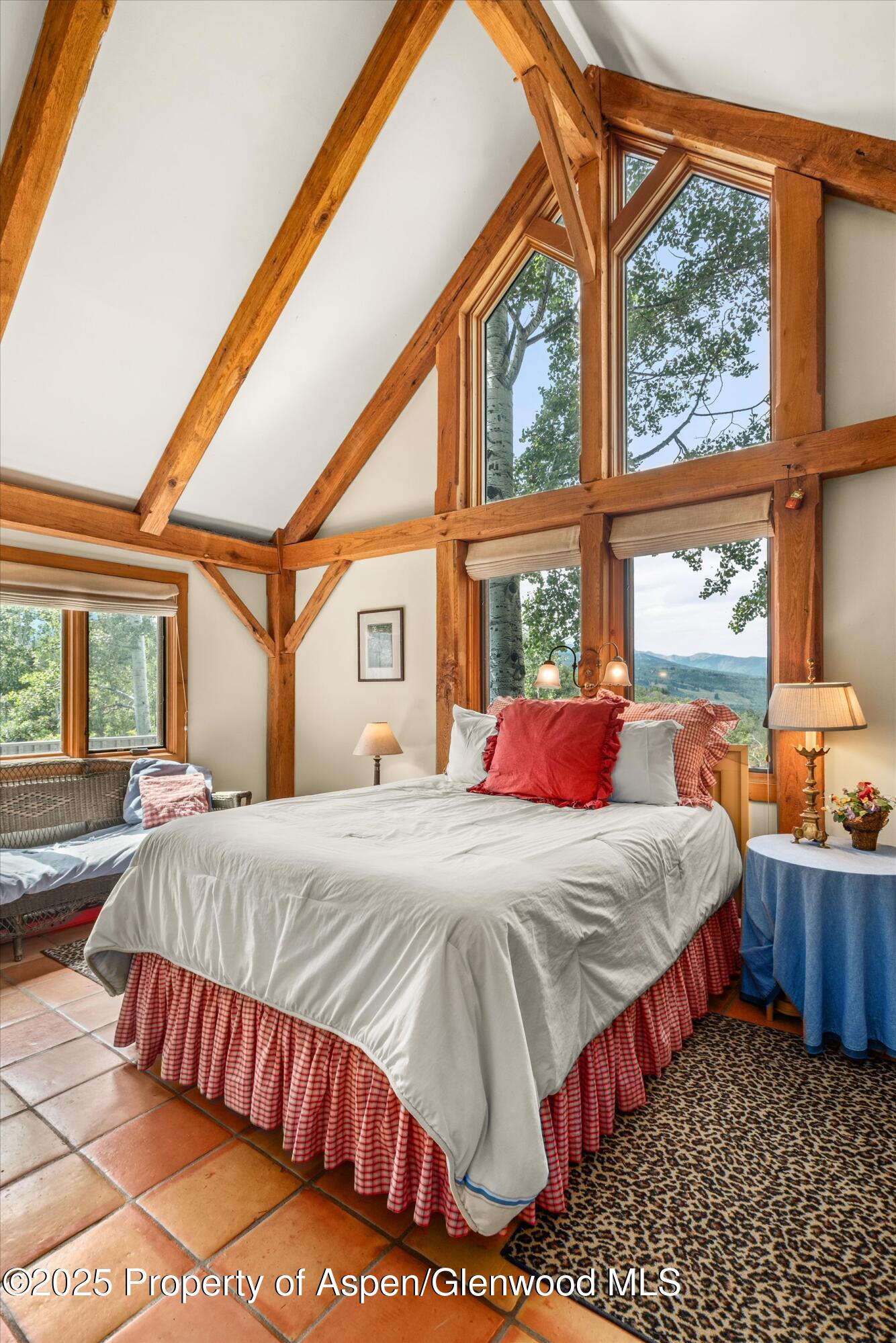 927 Red Mountain Road Aspen, CO 81612 - Photo 16 of 37 a bed sitting in a bedroom next to a window