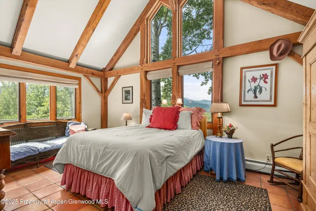 a view of a bedroom with a bed and a window