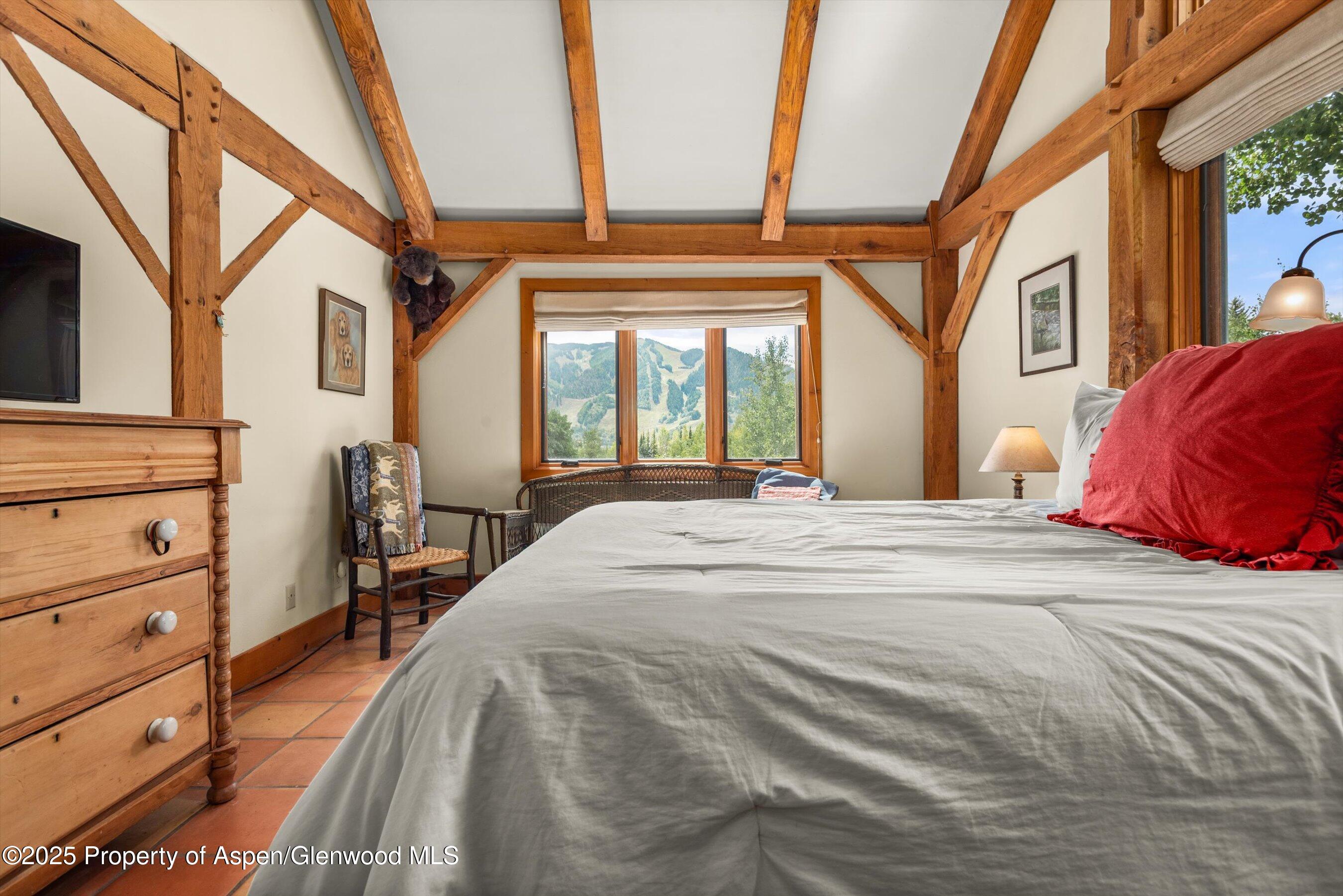 927 Red Mountain Road Aspen, CO 81612 - Photo 18 of 37 a view of a bedroom with a bed and a window