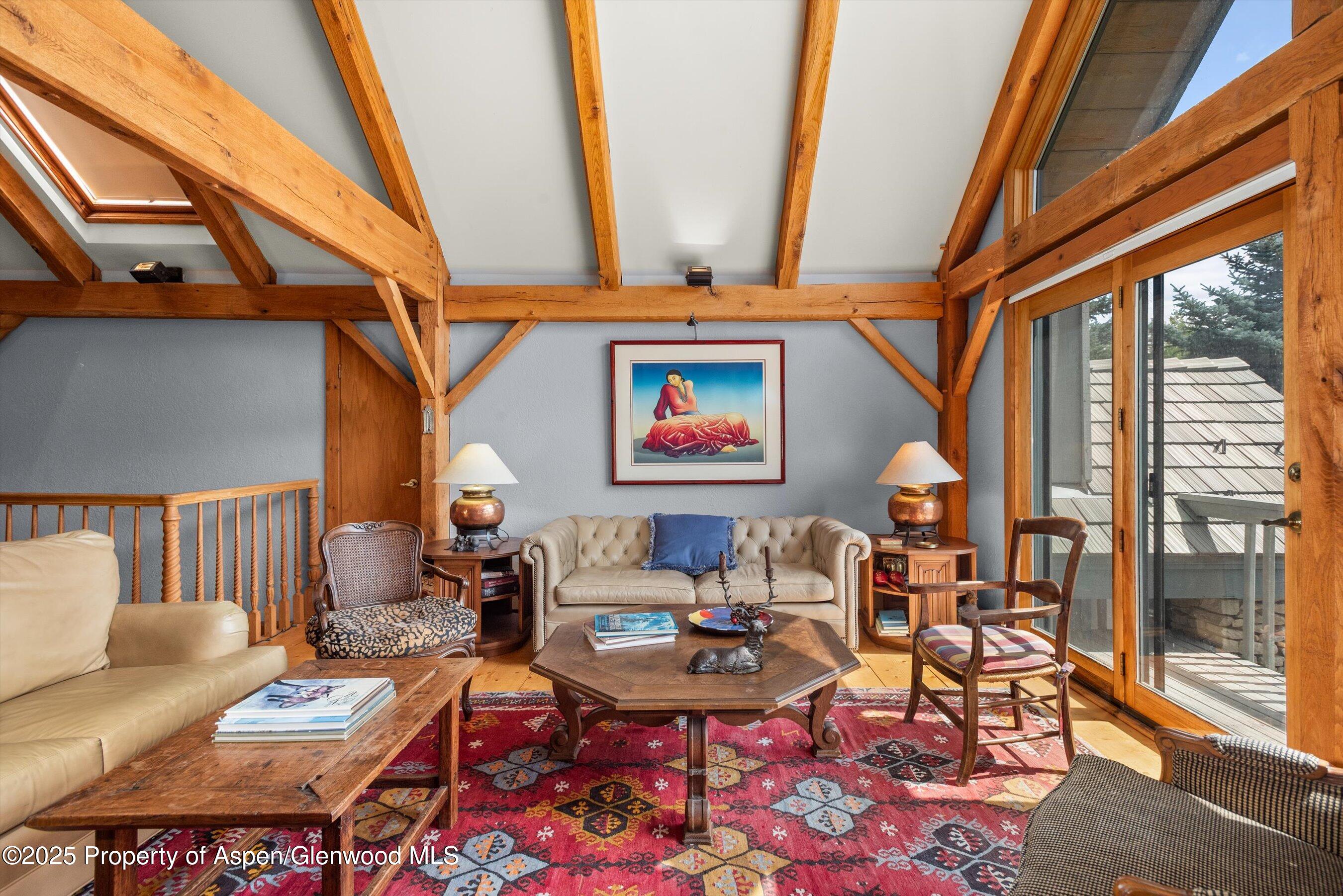 927 Red Mountain Road Aspen, CO 81612 - Photo 23 of 37 a living room with furniture and a floor to ceiling window