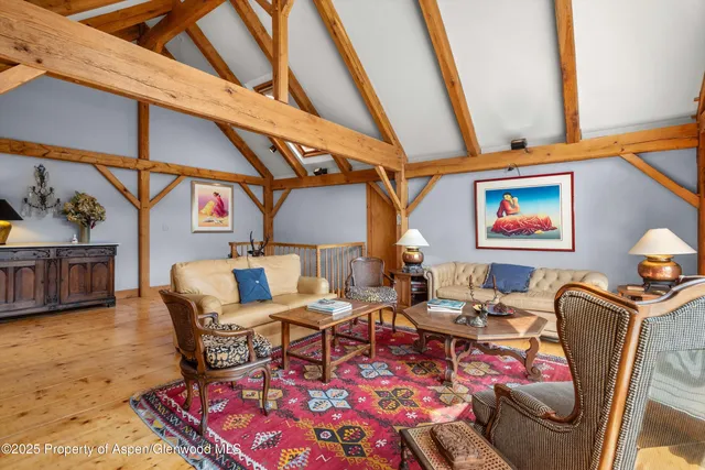 a living room with fireplace furniture and a floor to ceiling window