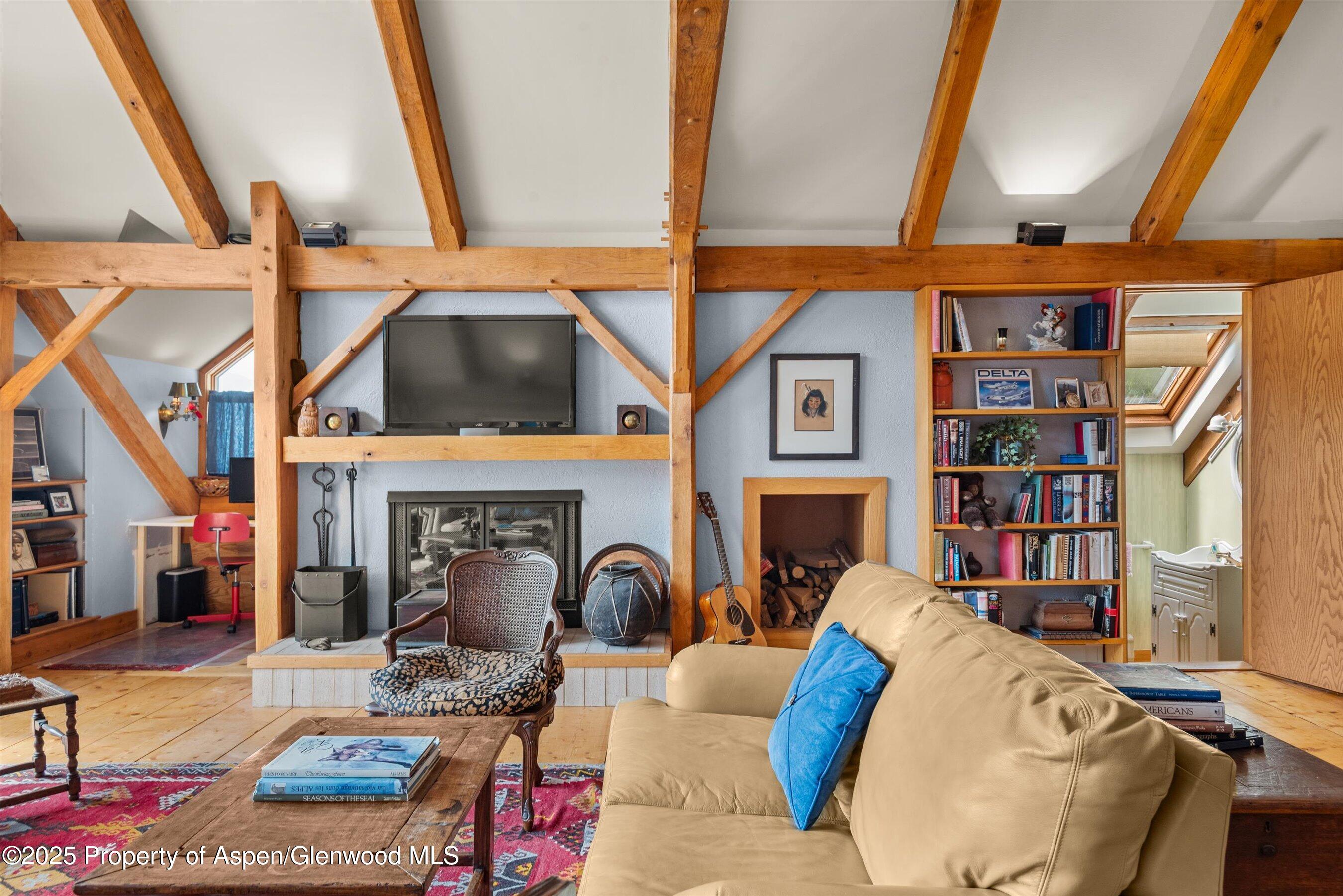 927 Red Mountain Road Aspen, CO 81612 - Photo 25 of 37 a living room with fireplace furniture and a floor to ceiling window