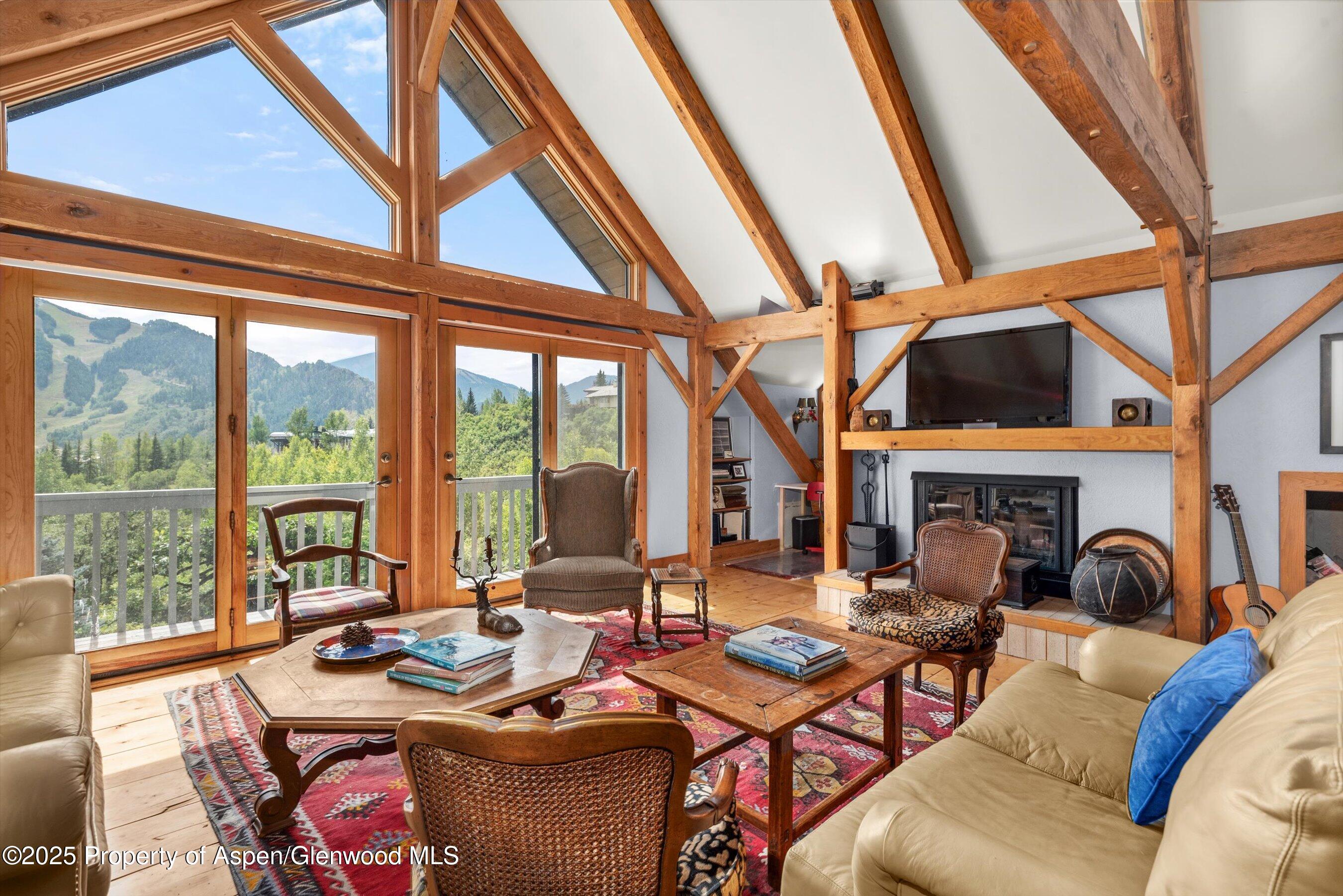 927 Red Mountain Road Aspen, CO 81612 - Photo 6 of 37 a living room with fireplace furniture and a large window