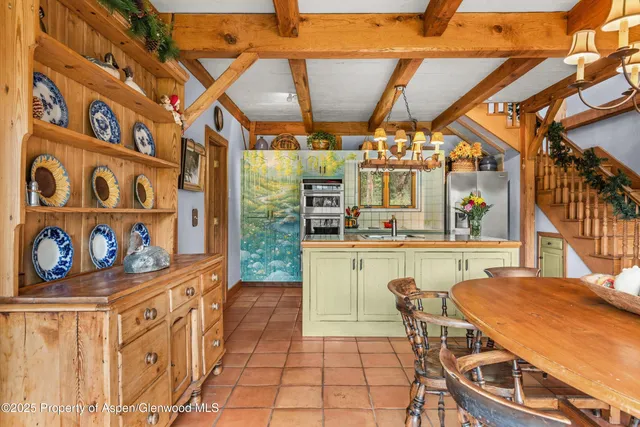 a dining room with furniture and a floor to ceiling window