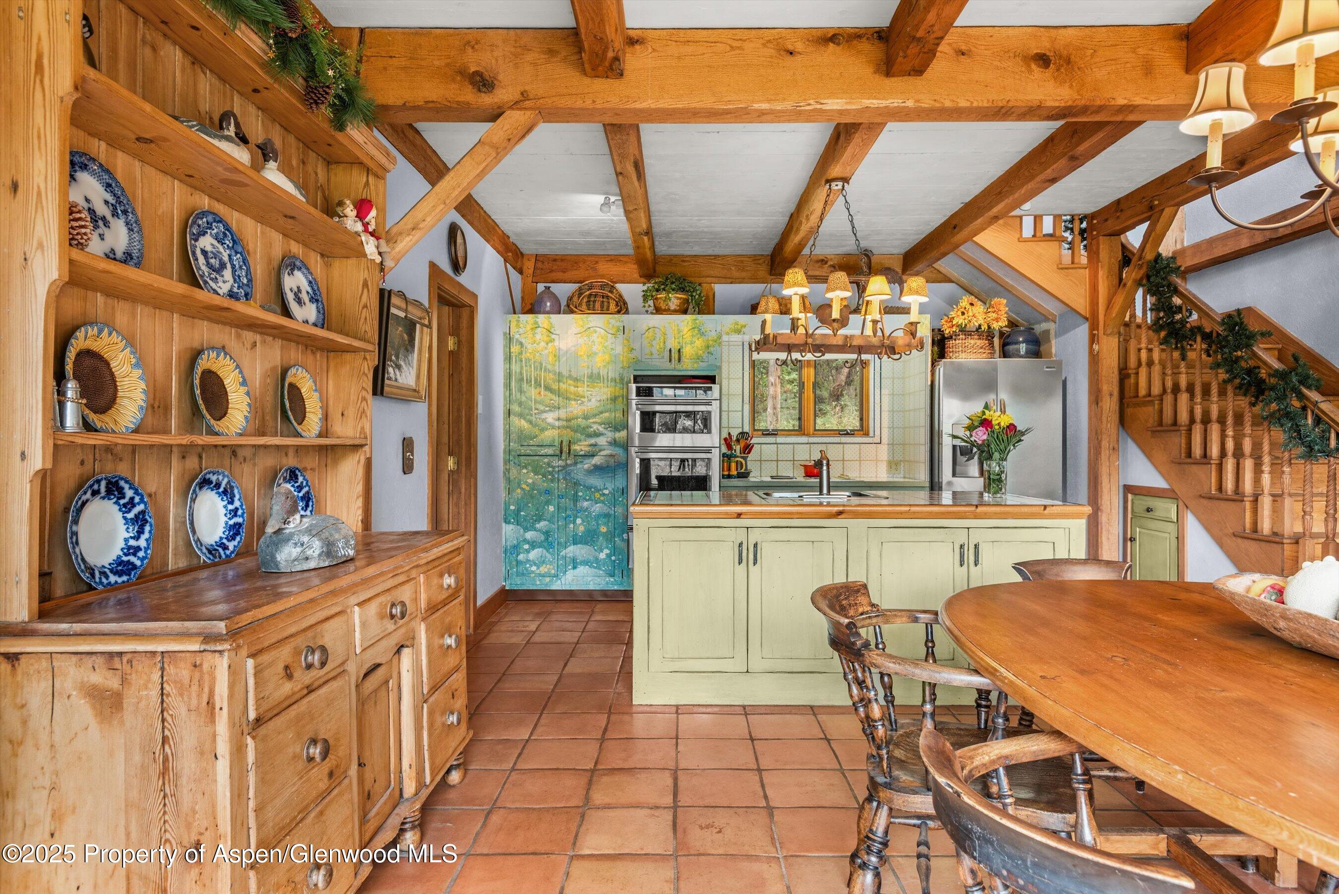 927 Red Mountain Road Aspen, CO 81612 - Photo 9 of 37 a dining room with furniture and a floor to ceiling window
