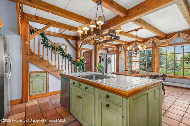 a living room with furniture a flat screen tv and a floor to ceiling window