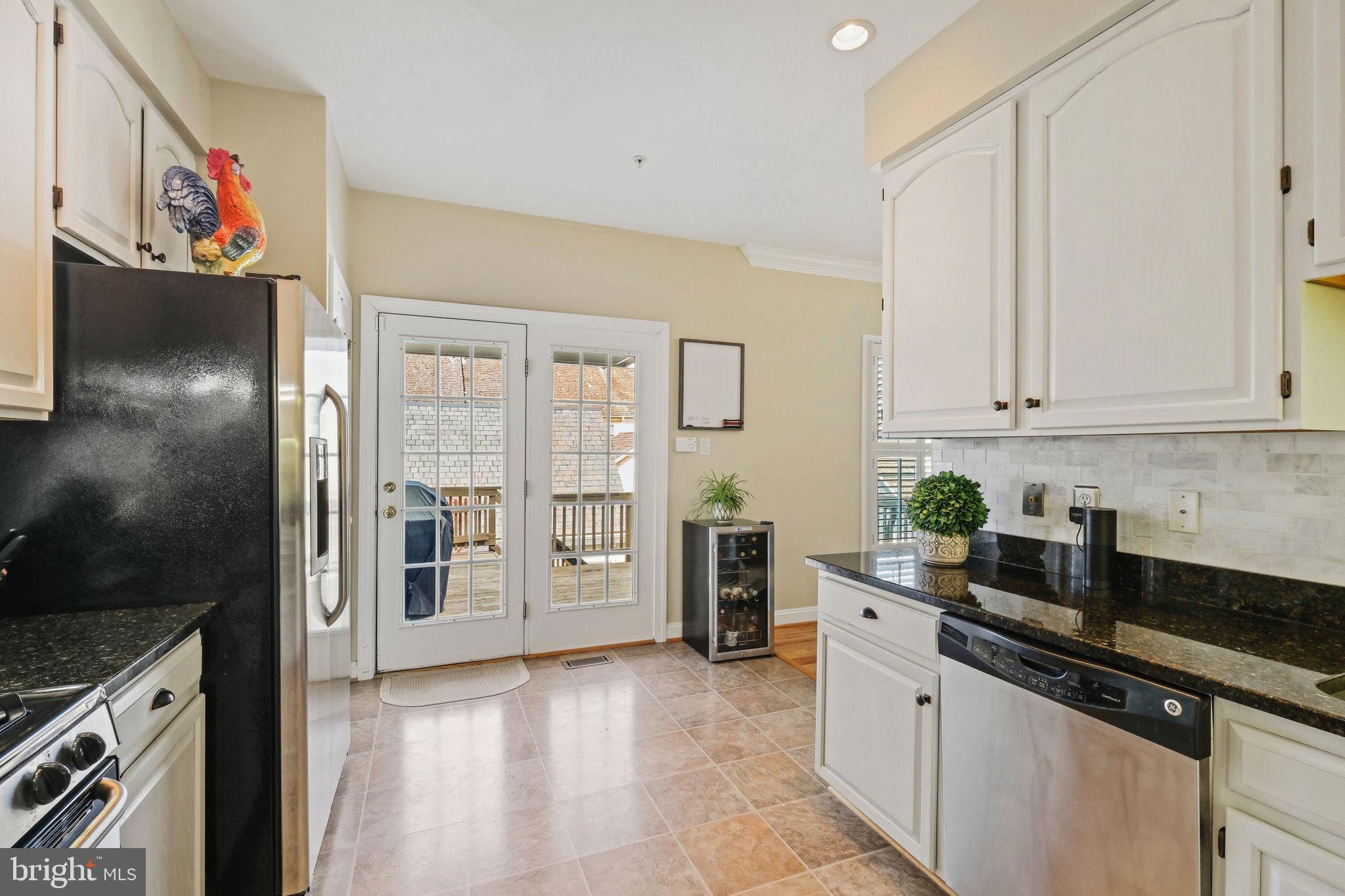 220 Thaxton Street Gaithersburg, MD 20878 - Photo 15 of 61 a kitchen with stainless steel appliances granite countertop a refrigerator and a stove