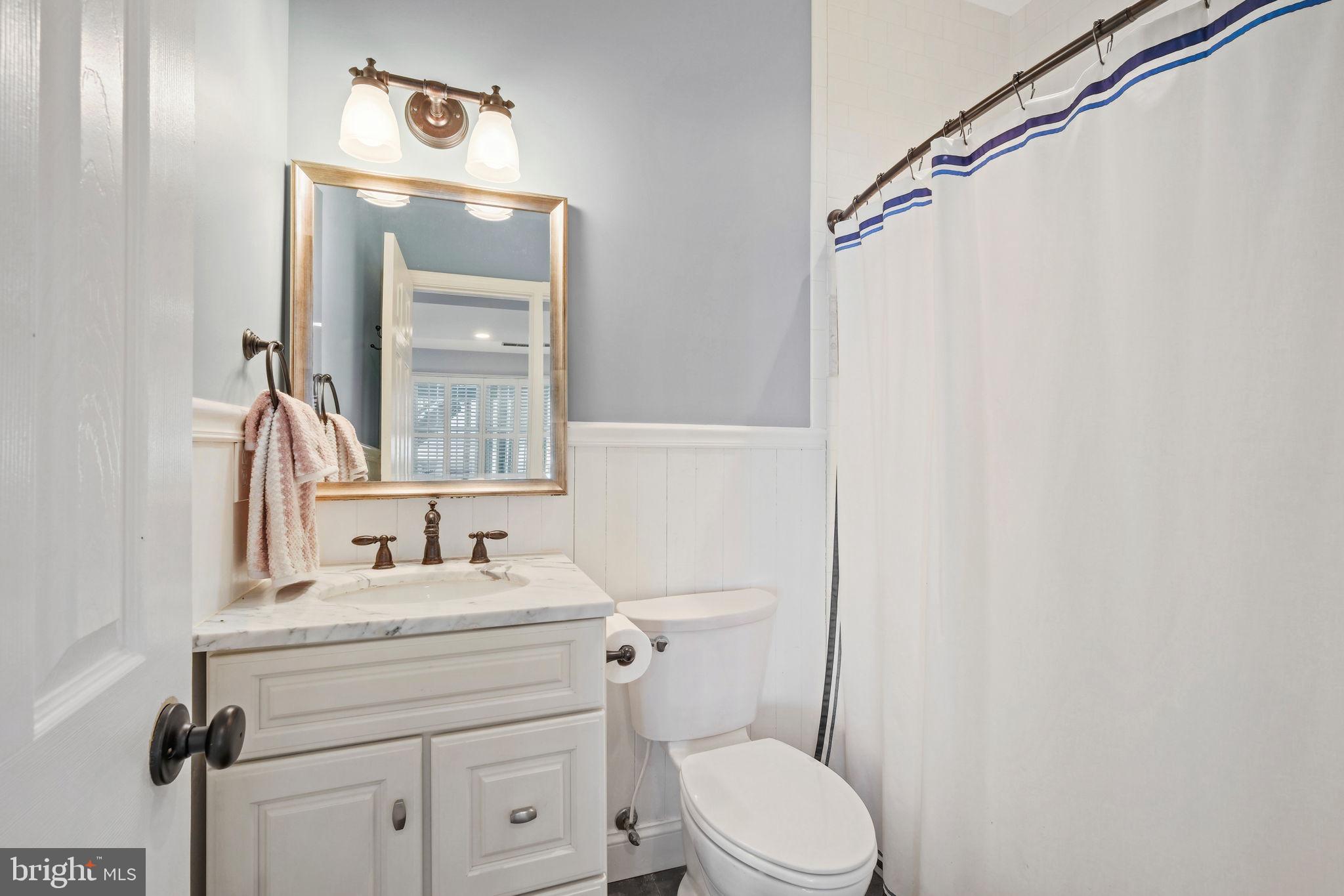 220 Thaxton Street Gaithersburg, MD 20878 - Photo 26 of 61 a bathroom with a sink vanity mirror and toilet