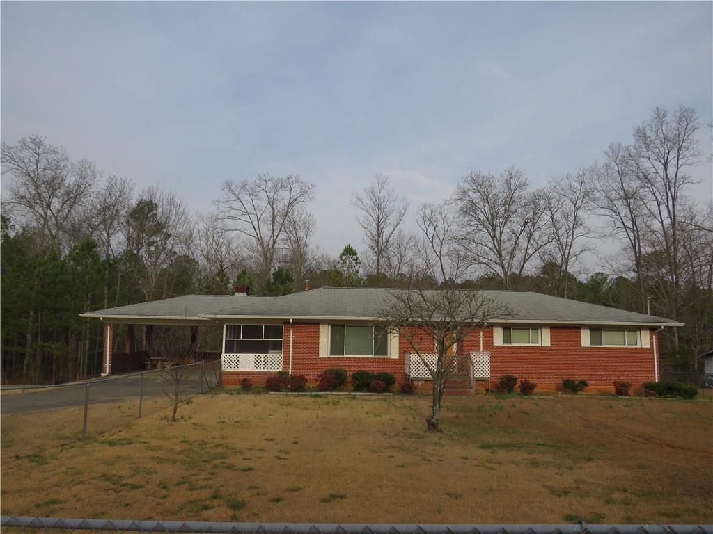 1406 North Bellview Road Rockmart, GA 30153 - Photo 1 of 1 a front view of a house with garden
