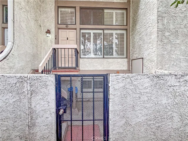 front view of a brick house with large windows